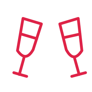 Two tilted stemmed glasses angle towards each other for a celebratory toast.