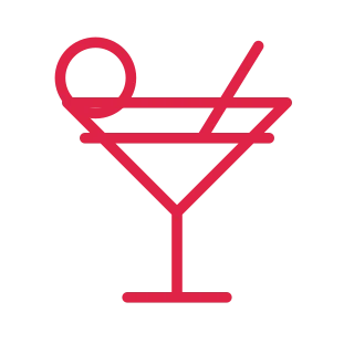 A triangular cocktail glass has a thin stem, a straw and a round garnish.