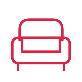 A wide sofa has a padded back, rounded armrests and short legs.