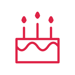 Three candles top a rectangular birthday cake with a scalloped icing line.