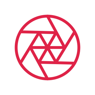 Six angled blades form a geometric camera aperture inside a circle.