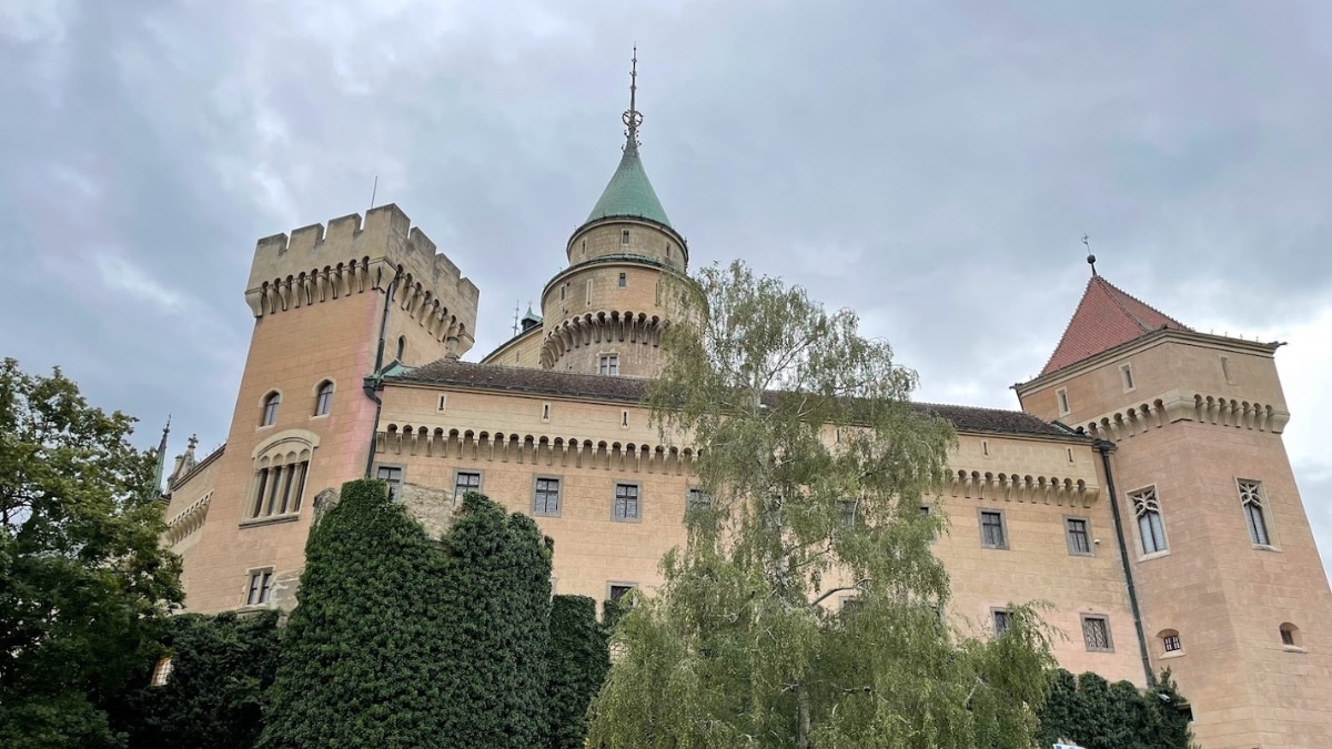 The magnificent Bojnice Castle in Slovakia, surrounded by lush greenery, showcasing its historic towers and medieval architecture.