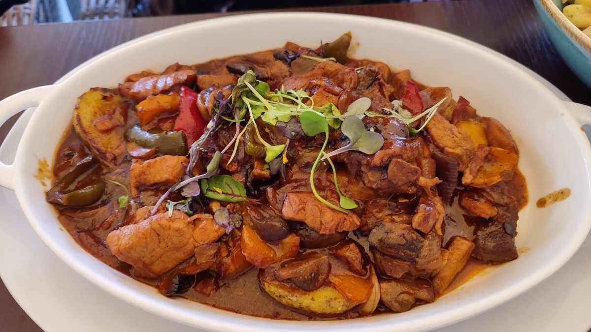 Flavorful mushroom sauté with tender meat, vegetables, and rich sauce, served in a white dish.