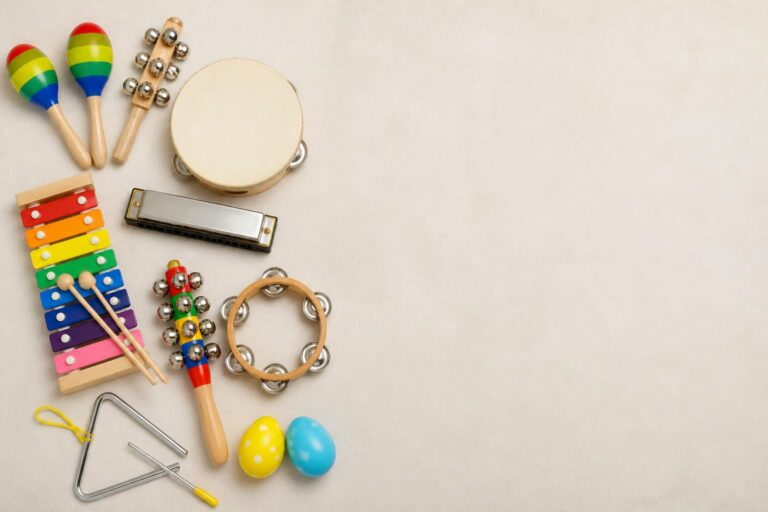 Various children's colorful musical instruments arranged on left side with empty space on right