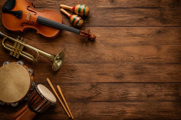 Various musical instruments including violin, trumpet, maracas, tambourine, and bongo drum on a wooden surface.