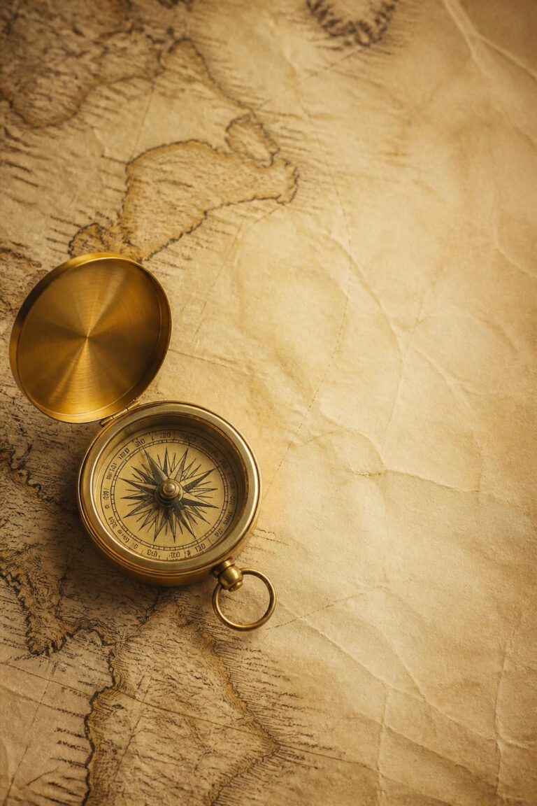 Antique brass compass with open lid on vintage world map showing South America